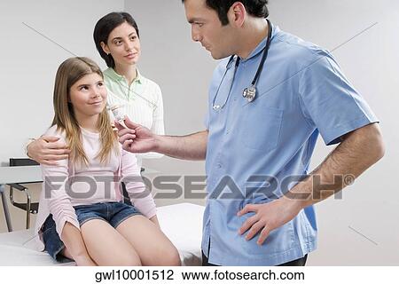 Doctor giving medicine to a patient View Large Photo Image Stock Image - Doctor giving medicine to a patient. Fotosearch