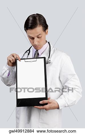 Picture - Doctor holding a clip board. Fotosearch