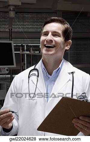 Doctor holding a clipboard and laughing View Large Photo Image Stock Photo - Doctor holding a clipboard and laughing. Fotosearch