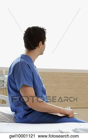 Doctor holding a clipboard View Large Photo Image Stock Image - Doctor holding a clipboard. Fotosearch