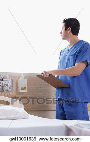 Stock Photograph - Doctor holding a clipboard. Fotosearch