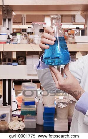 Doctor holding a conical flask in a laboratory View Large Photo Image Stock Photography - Doctor holding a conical flask in a laboratory. Fotosearch