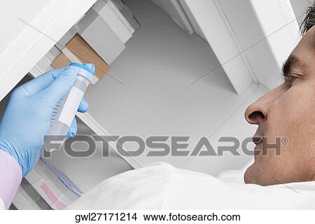 Doctor holding a medical sample in a laboratory View Large Photo Image Picture - Doctor holding a medical sample in a laboratory. Fotosearch