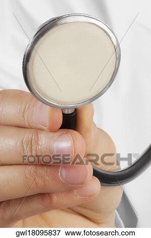 Doctor holding a stethoscope View Large Photo Image Stock Photo - Doctor holding a stethoscope. Fotosearch