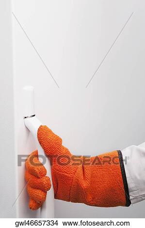 Doctor holding the handle of a refrigerator in a lab View Large Photo Image Picture - Doctor holding the handle of a refrigerator in a lab. Fotosearch