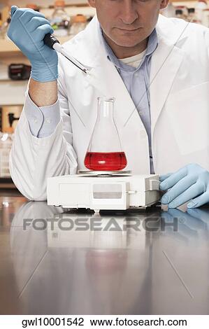 Doctor researching in a laboratory View Large Photo Image Stock Image - Doctor researching in a laboratory. Fotosearch