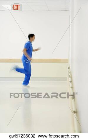 Stock Image - Doctor running in a hospital corridor. Fotosearch
