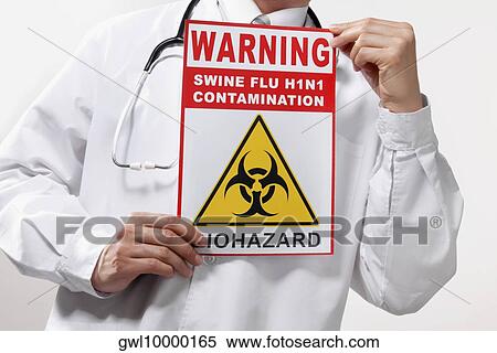 Doctor showing a Biohazard warning sign View Large Photo Image Stock Photography - Doctor showing a Biohazard warning sign. Fotosearch