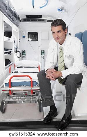 Doctor sitting in an ambulance View Large Photo Image Picture - Doctor sitting in an ambulance. Fotosearch