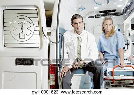 Doctor sitting with a female nurse in an ambulance View Large Photo Image Stock Image - Doctor sitting with a female nurse in an ambulance. Fotosearch