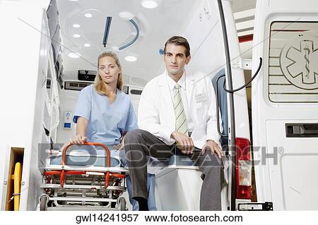 Doctor sitting with a female nurse in an ambulance View Large Photo Image Stock Photo - Doctor sitting with a female nurse in an ambulance. Fotosearch