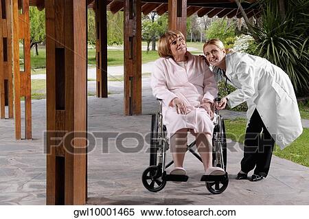 Doctor smiling with her patient View Large Photo Image Stock Photography - Doctor smiling with her patient. Fotosearch