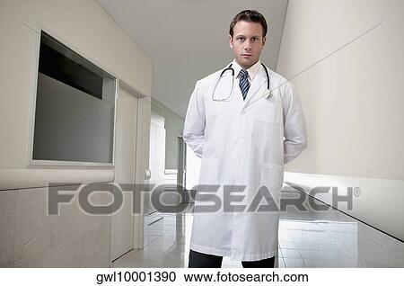 Doctor standing in the corridor of a hospital View Large Photo Image Stock Image - Doctor standing in the corridor of a hospital. Fotosearch
