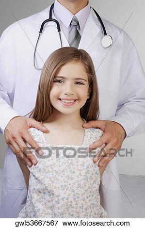 Doctor standing with a girl View Large Photo Image Stock Photo - Doctor standing with a girl. Fotosearch