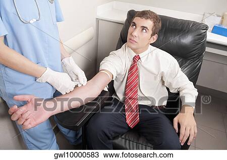 Doctor taking blood sample of a man View Large Photo Image Stock Image - Doctor taking blood sample of a man. Fotosearch