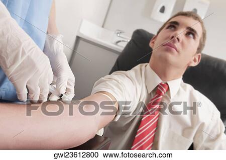 Doctor taking blood sample of a man View Large Photo Image Stock Image - Doctor taking blood sample of a man. Fotosearch