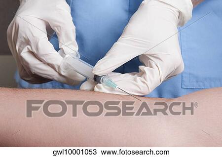 Doctor taking blood sample of a patient View Large Photo Image Stock Image - Doctor taking blood sample of a patient. Fotosearch