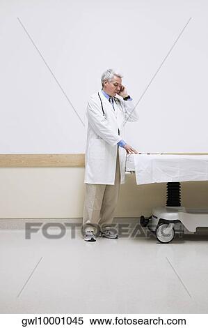 Stock Photography - Doctor talking on a mobile phone. Fotosearch