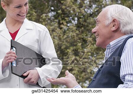 Picture - Doctor talking with a man. Fotosearch