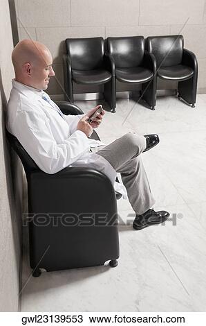 Doctor text messaging on a mobile phone View Large Photo Image Stock Image - Doctor text messaging on a mobile phone. Fotosearch