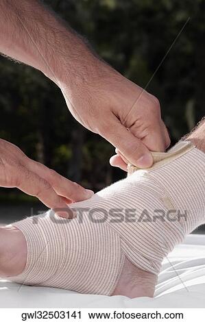 Doctor tying crepe bandage on a patient's foot View Large Photo Image Stock Image - Doctor tying crepe bandage on a patient's foot. Fotosearch