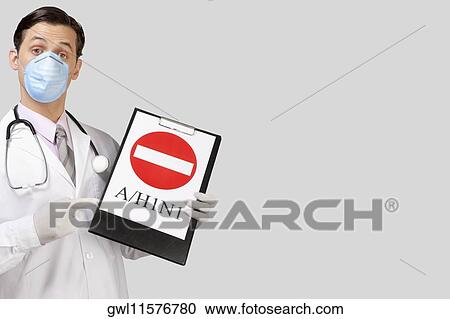 Doctor wearing a flu mask and showing Do Not Enter sign View Large Photo Image Stock Image - Doctor wearing a flu mask and showing Do Not Enter sign. Fotosearch