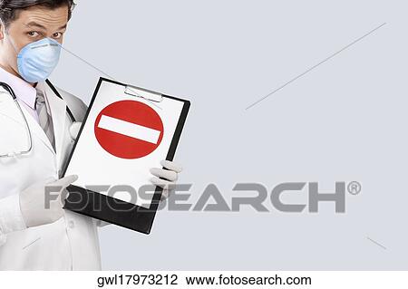 Doctor wearing a flu mask and showing Do Not Enter sign View Large Photo Image Stock Image - Doctor wearing a flu mask and showing Do Not Enter sign. Fotosearch