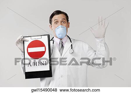 Doctor wearing a flu mask and showing Do Not Enter sign View Large Photo Image Stock Photo - Doctor wearing a flu mask and showing Do Not Enter sign. Fotosearch