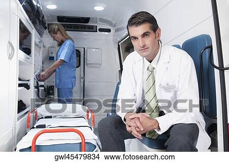 Picture - Doctor with a female nurse in an ambulance. Fotosearch