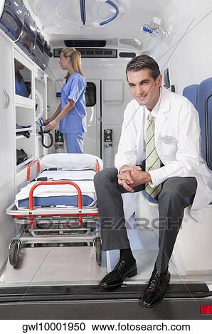 Stock Image - Doctor with a female nurse in an ambulance. Fotosearch