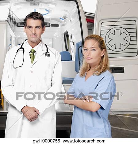 Doctor with a female nurse standing in front of an ambulance View Large Photo Image Stock Photography - Doctor with a female nurse standing in front of an ambulance. Fotosearch