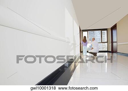 Doctor with a girl in the corridor View Large Photo Image Stock Photo - Doctor with a girl in the corridor. Fotosearch