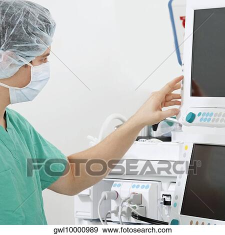 Doctor working on a cardiac monitor screen View Large Photo Image Stock Photo - Doctor working on a cardiac monitor screen. Fotosearch