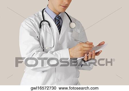 Stock Image - Doctor writing a prescription. Fotosearch