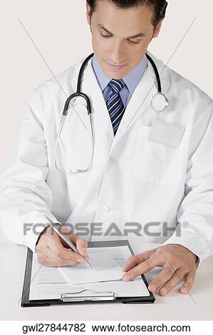 Doctor writing on a clipboard View Large Photo Image Stock Image - Doctor writing on a clipboard. Fotosearch