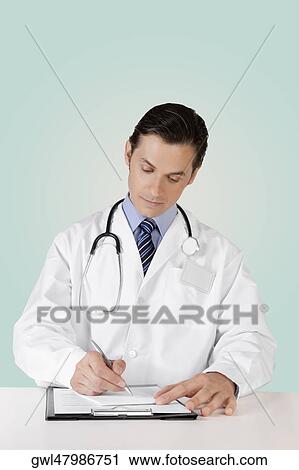 Doctor writing on a clipboard View Large Photo Image Stock Image - Doctor writing on a clipboard. Fotosearch