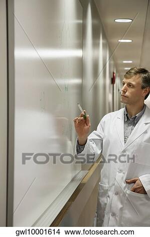 Doctor writing on a whiteboard in a hospital View Large Photo Image Picture - Doctor writing on a whiteboard in a hospital. Fotosearch