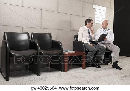 Doctors discussing a medical report View Large Photo Image Picture - Doctors discussing a medical report. Fotosearch