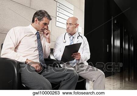 Doctors discussing a medical report View Large Photo Image Stock Image - Doctors discussing a medical report. Fotosearch
