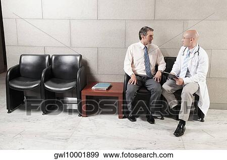 Doctors discussing a medical report View Large Photo Image Stock Photo - Doctors discussing a medical report. Fotosearch