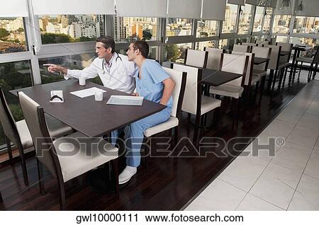 Doctors during coffee break a cafeteria View Large Photo Image Stock Image - Doctors during coffee break a cafeteria. Fotosearch