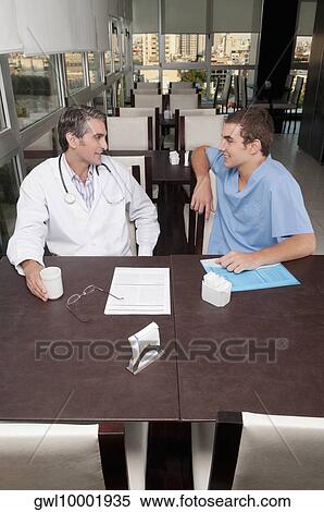Doctors during coffee break a cafeteria View Large Photo Image Stock Photography - Doctors during coffee break a cafeteria. Fotosearch
