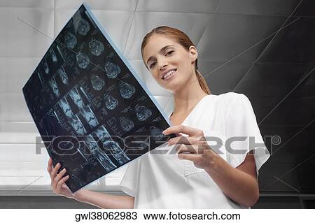 Doctors examining an X-Ray report View Large Photo Image Stock Image - Doctors examining an X-Ray report. Fotosearch