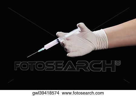 Doctor's hand holding an injection View Large Photo Image Picture - Doctor's hand holding an injection. Fotosearch