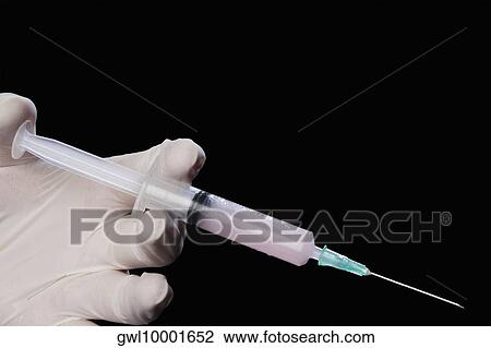 Doctor's hand holding an injection View Large Photo Image Stock Image - Doctor's hand holding an injection. Fotosearch