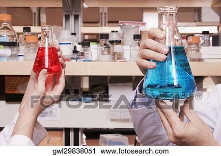 Doctors holding conical flasks in a laboratory View Large Photo Image Stock Image - Doctors holding conical flasks in a laboratory. Fotosearch