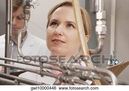 Doctors researching in a laboratory View Large Photo Image Stock Photograph - Doctors researching in a laboratory. Fotosearch