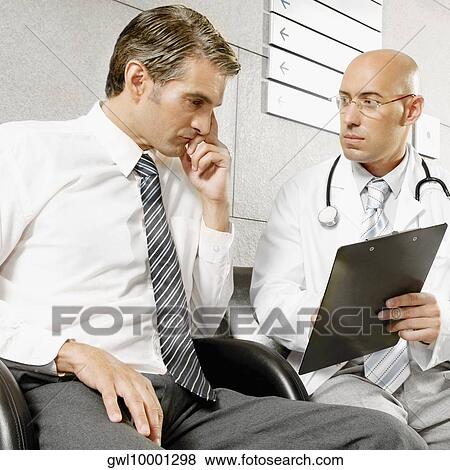 Stock Photo - Doctors talking to each other. Fotosearch