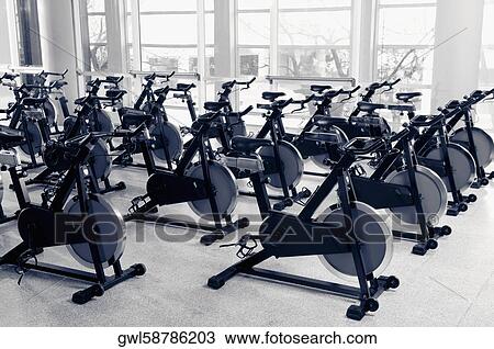 Exercise bikes in a gym View Large Photo Image Stock Image - Exercise bikes in a gym. Fotosearch