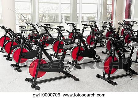 Exercise bikes in a gym View Large Photo Image Stock Photograph - Exercise bikes in a gym. Fotosearch